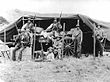B&W photo of Boers on an ammunition wagon under a tarpaulin
