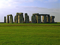 Stonehenge with trimmed green grass on a partly-sunny day