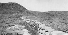 Contemporary photograph looking down a Boer trench located at the foot of a hill