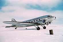 Right side view of an aircraft parked on snow-covered ground.