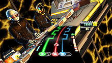A video game screen. At the bottom, a curved arc shows three colored lines (green, red, and blue) that have round gems on them as well as move back and forth along the arc. A meter shows a scoring value and number of stars. Above and behind this, two human characters are using shown using a turntable mixer; the two characters are wearing black, futuristic objects and wear helmets to mask their identity.