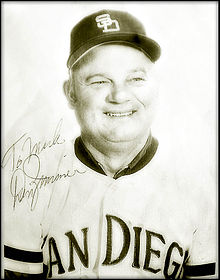 A middle-aged man wearing a light-colored San Diego baseball uniform; the photograph bears a signature saying "Don Zimmer"