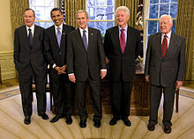 Group portrait of five presidential men in dark suits and ties