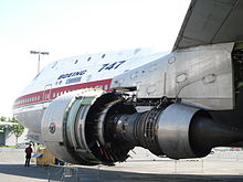 The Pratt & Whitney JT9D turbofan suspended under the wing pylon of the 747 prototype. It is stripped of its outer casing, revealing the engine's core