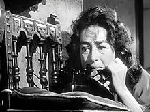Facial shot of a dishevelled Crawford on the telephone.