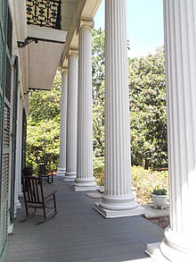View of portico at Magnolia Hall with rocking chairs