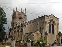 Stone building with arched windows and square tower.
