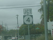 Signage depicting the Route 4 sign with an old bridge in the distance