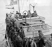 Soldiers crowded on the deck deck of a Motor Torpedo Boat
