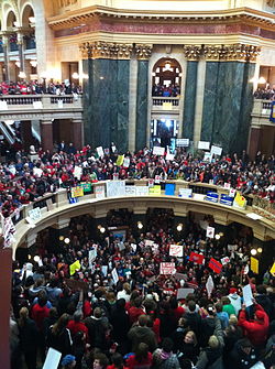 Overhead view of hundreds of people wearing red for the Teachers' union, protesting against Walker's bill.