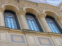 The upper windows of the facade are surrounded by rich carvings.