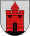 A coat of arms depicting a red castle with black double doors, two black windows, and one central tower all standing on black ground