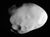 A potato shaped body is illuminated from the right. The terminator runs from the top to bottom. There is a large crater at the bottom near the terminator. The body is elongated from the right to left.