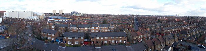 Regular rows of red brick houses stretch into the distance