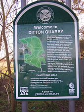 A photograph of a sign saying "Welcome to Ditton Quarry" and explaining the history of the nature reserve and containing an outline map of the walks available to visitors