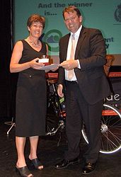 Hon Jonathan Young presenting a certificate, and winner Margaret Parfitt from Nelson City Council holding a trophy