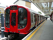 Red and grey train with unusually large windows