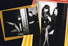 A collage of two black-and-white images with brighty colored borders in a black background. The first picture features a brunette woman, wearing a black dress and fishnet stockings and leaning suggestively against a confessional. A young priest sits on the other side of the partition. The second image shows the same brunette woman sitting on the priest's lap.