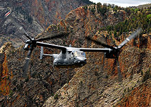 A CV-22 flying over mountainous terrain in New Mexico