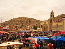 A crowd gathered in front of the Sanctuary of the Virgin of Socavón.