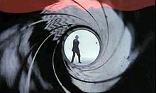 The figure of silhouetted man points a gun straight at the camera.