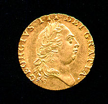 Gold coin bearing the profile of a round-headed man wearing a classical Roman-style haircut and laurel-wreath.