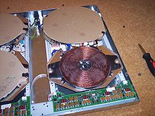 Large flat copper coil, with electronic circuit board adjacent