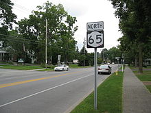 NY 65 and a shield in residential Honeoye Falls