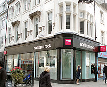 A branch of the Northern Rock bank. Some people are walking-by.