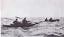 two two man canoes at sea moving from left to right