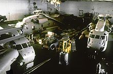 Three helicopters in the hangar of Nimitz