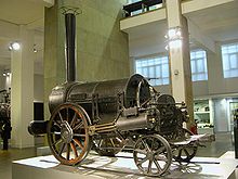 Small black steam locomotive with unusually large front wheels.