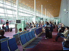 Departure lounge with large windows for light and aircraft viewing.
