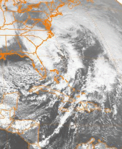 A satellite image of the eastern United States and western Caribbean Sea, depicting two large storms.