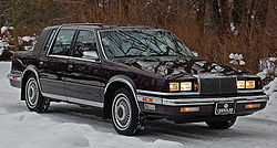 1991 Chrysler New Yorker Fifth Avenue Mark Cross Edition sedan (headlight covers open because lights are on)