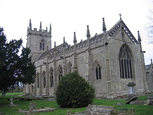 A grey stone church seen from the southeast, showing a chancel with a Perpendicular east window, an openwork parapet and pinnacles and, beyond that, the nave and a tower, also with pinnacles